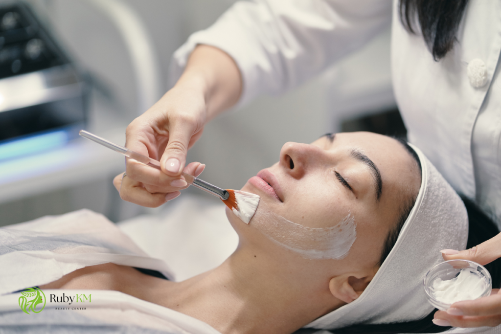 Esthetician applying a facial peel treatment