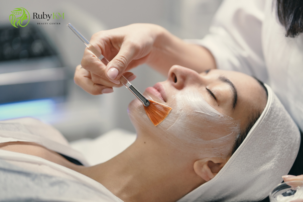 Woman receiving a light acid peel treatment on her face