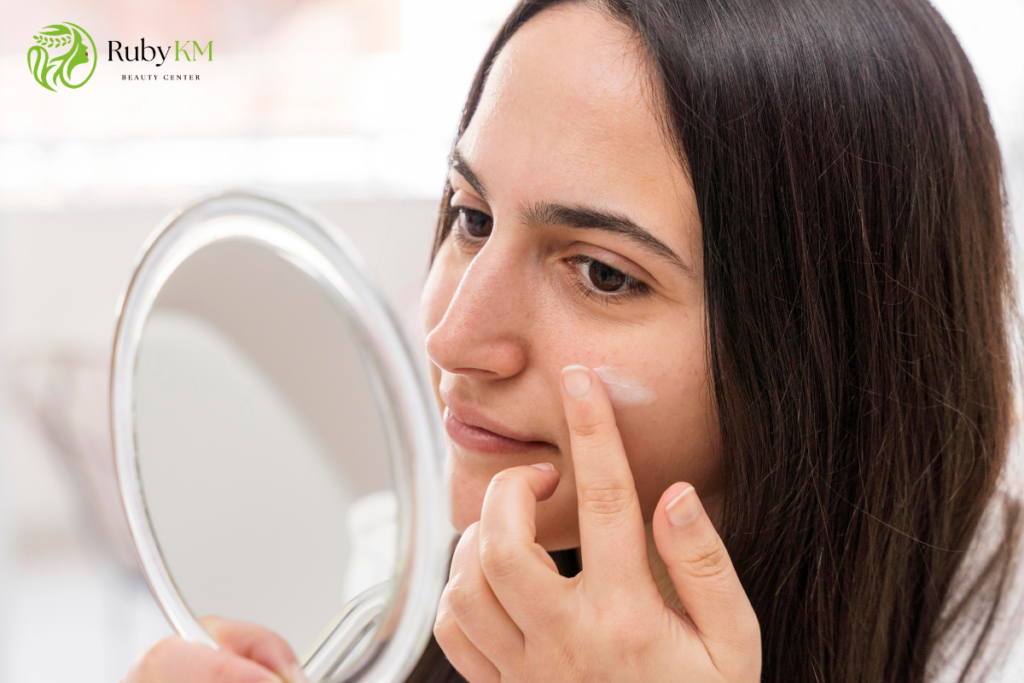 Woman applying facial moisturiser to dry skin 